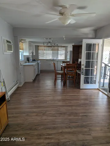 a kitchen with sink cabinets and wooden floor