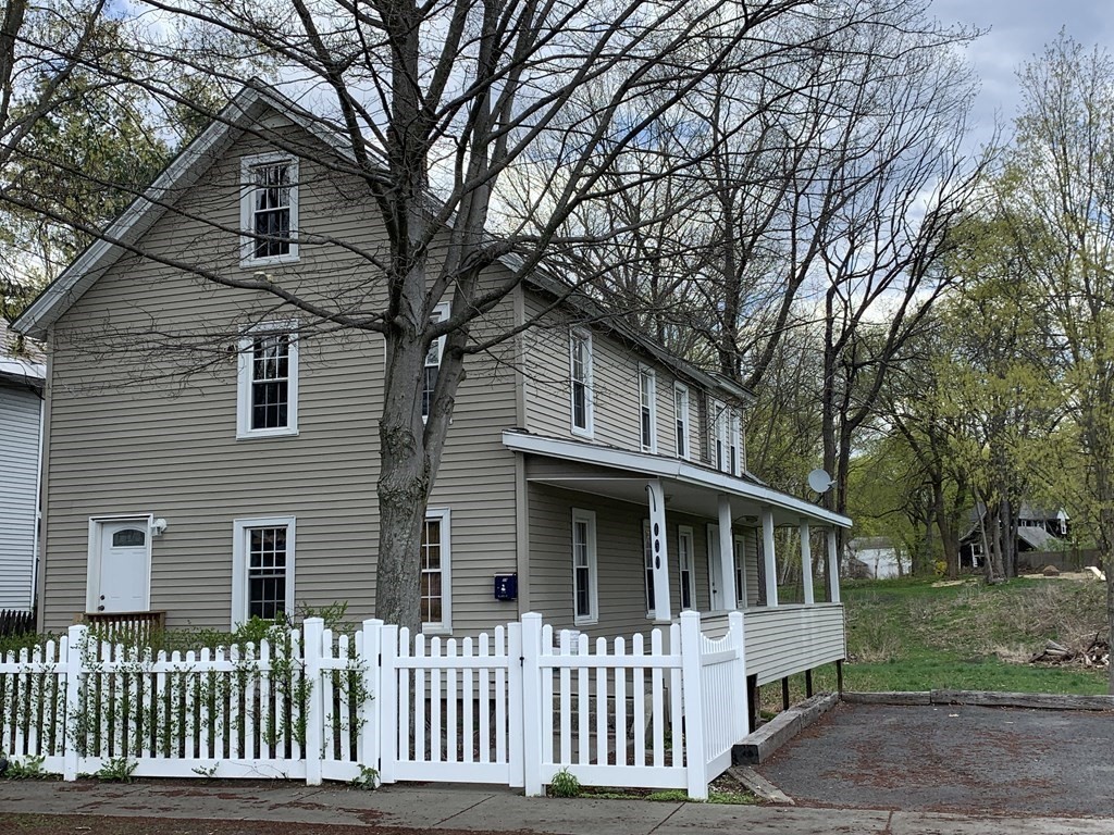 159 Chapman Street Greenfield, MA 01301 - Photo 1 of 36 a front view of a house with a garden