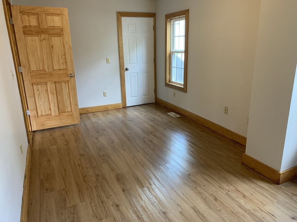 159 Chapman Street Greenfield, MA 01301 - Photo 13 of 36 an empty room with wooden floor and windows