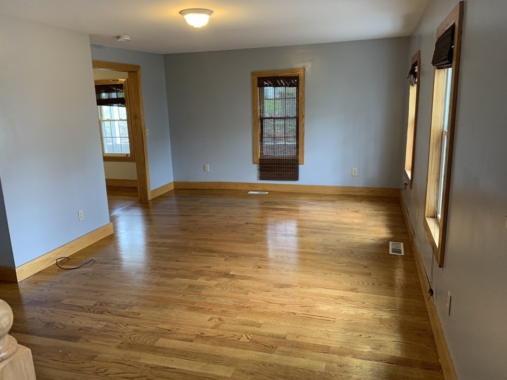 159 Chapman Street Greenfield, MA 01301 - Photo 16 of 36 a view of an empty room with window and wooden floor