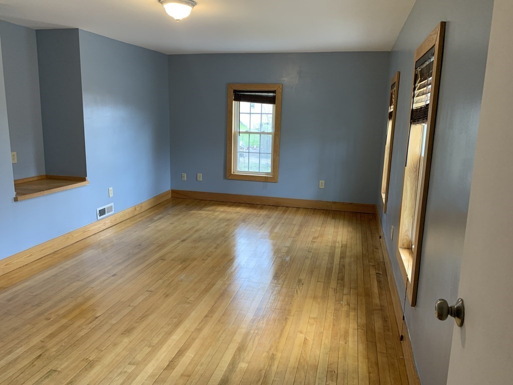159 Chapman Street Greenfield, MA 01301 - Photo 19 of 36 a view of an empty room with wooden floor and a window