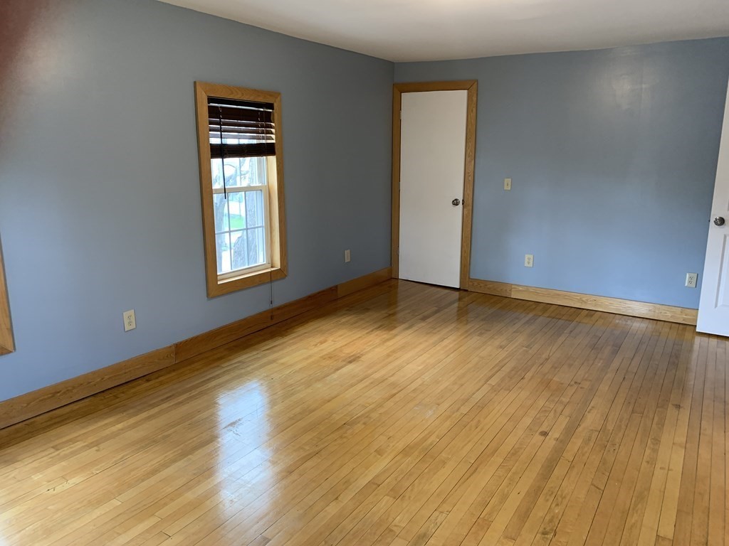 159 Chapman Street Greenfield, MA 01301 - Photo 20 of 36 a view of an empty room with wooden floor and a window