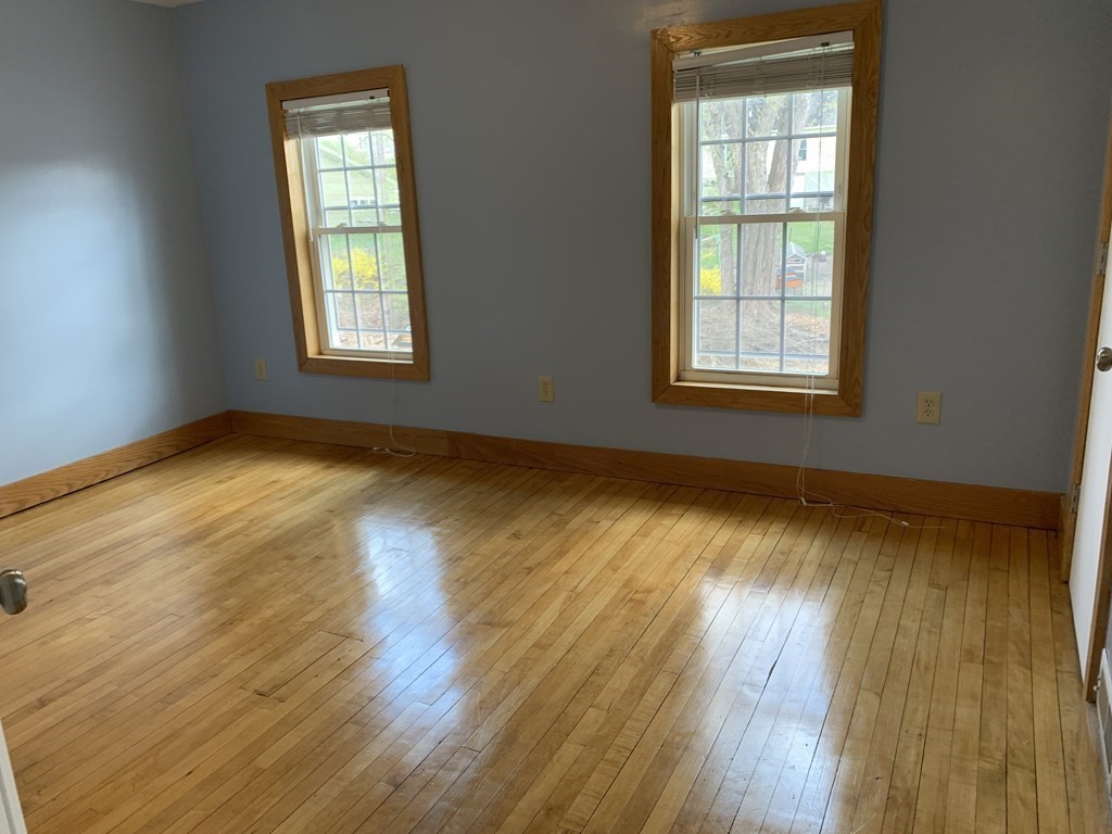 159 Chapman Street Greenfield, MA 01301 - Photo 26 of 36 an empty room with wooden floor and windows