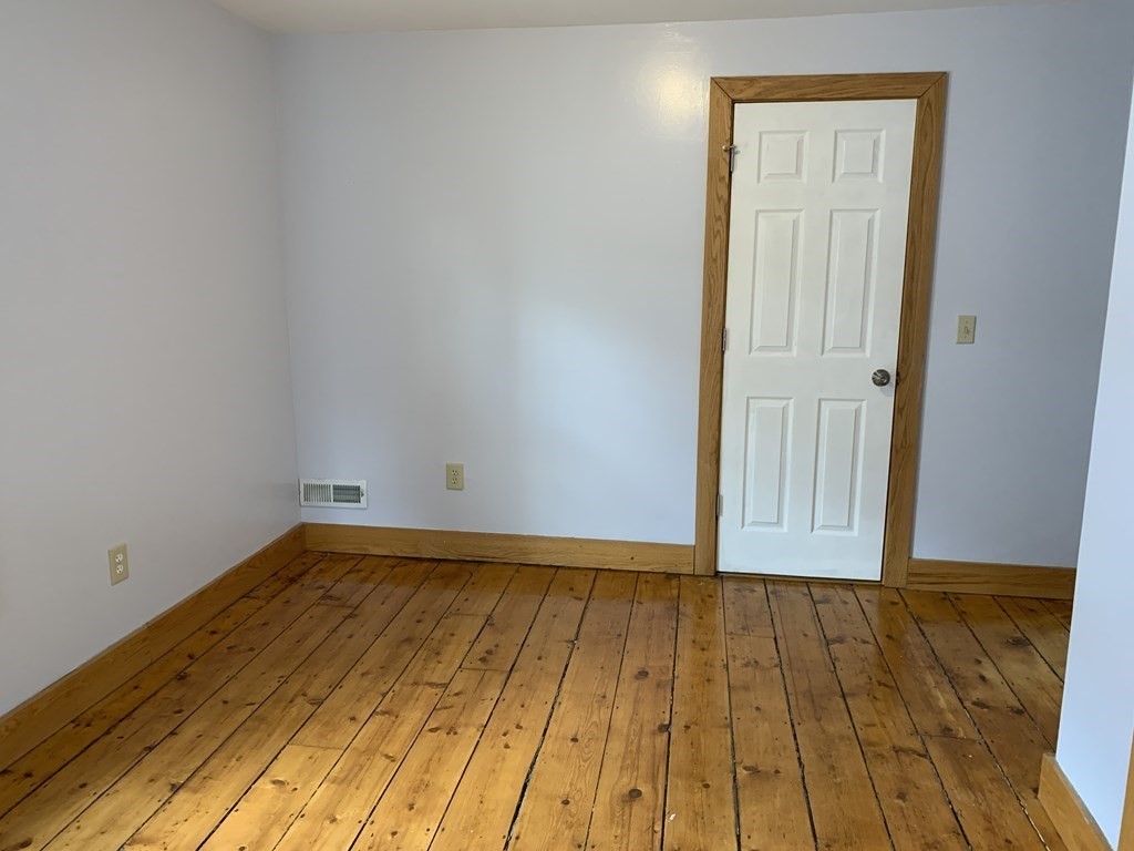 159 Chapman Street Greenfield, MA 01301 - Photo 28 of 36 a view of a room with wooden floor and brick wall