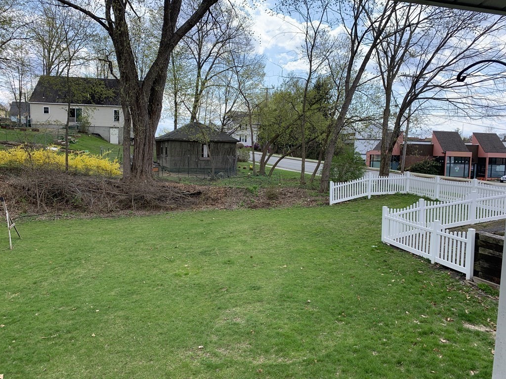 159 Chapman Street Greenfield, MA 01301 - Photo 3 of 36 a view of a house with a yard chairs and a large tree