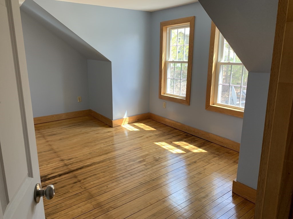 159 Chapman Street Greenfield, MA 01301 - Photo 31 of 36 a view of an empty room with wooden floor and a window
