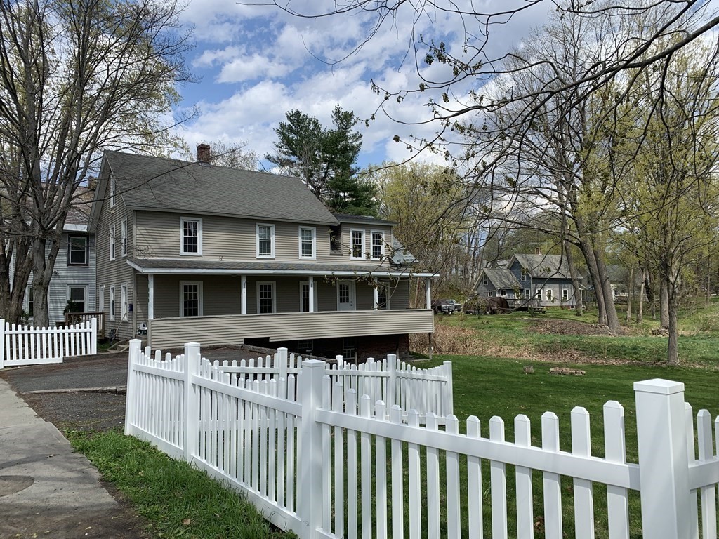 159 Chapman Street Greenfield, MA 01301 - Photo 36 of 36 a view of a house with a wooden deck and a yard