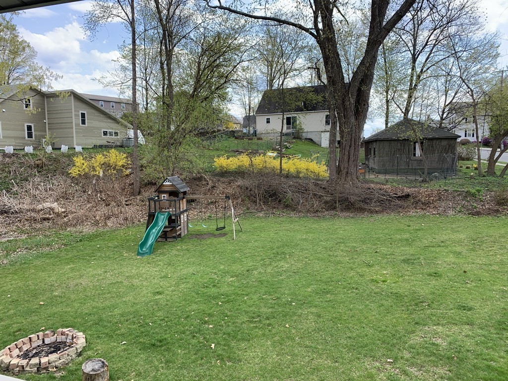 159 Chapman Street Greenfield, MA 01301 - Photo 4 of 36 a view of a backyard with a garden and swing