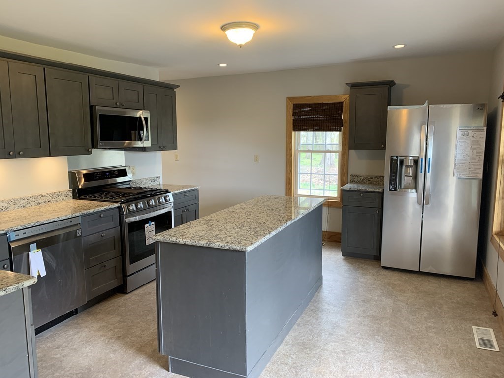 159 Chapman Street Greenfield, MA 01301 - Photo 6 of 36 a kitchen with stainless steel appliances granite countertop a refrigerator stove and microwave