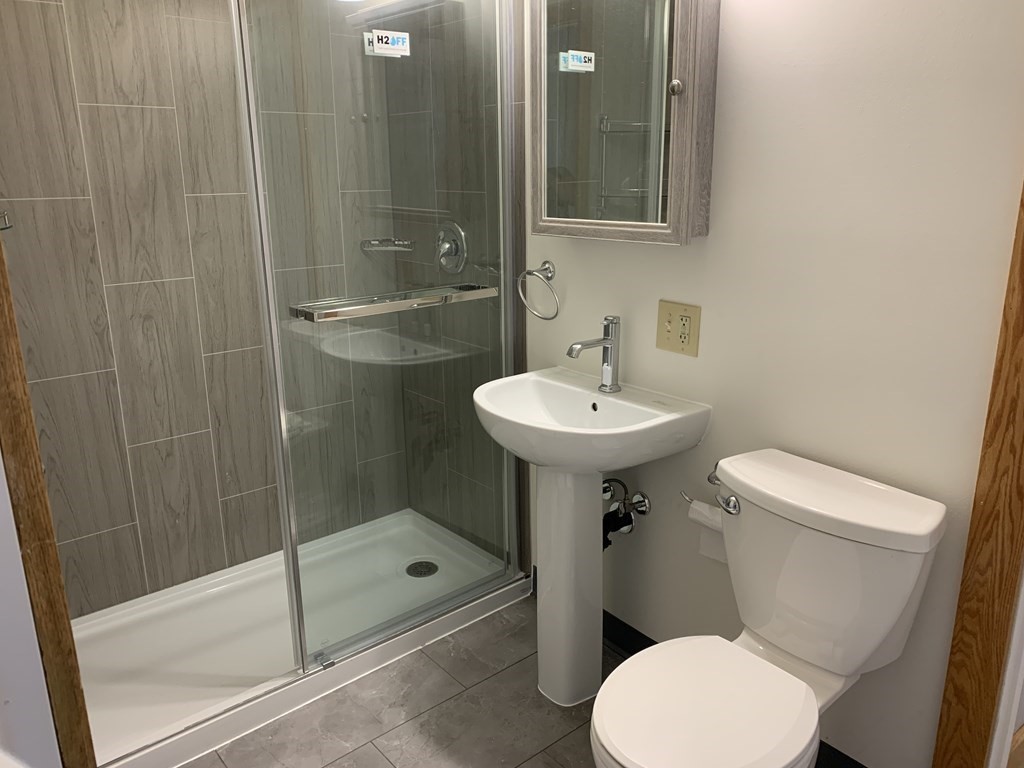 159 Chapman Street Greenfield, MA 01301 - Photo 8 of 36 a bathroom with a sink a toilet and shower