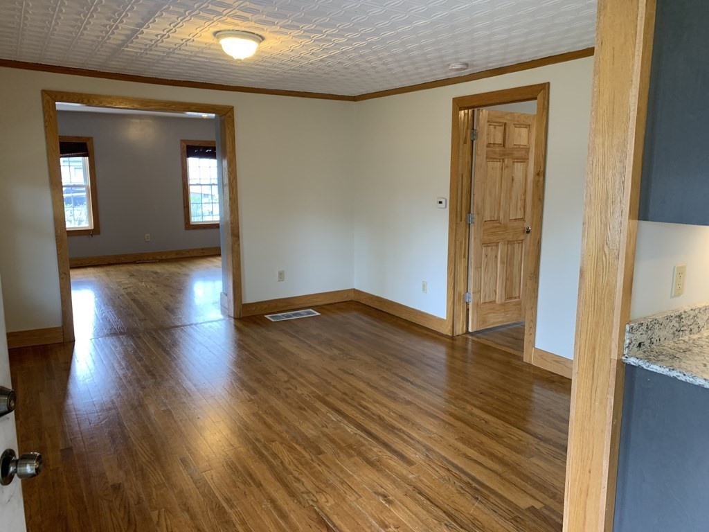 159 Chapman Street Greenfield, MA 01301 - Photo 9 of 36 an empty room with wooden floor and windows