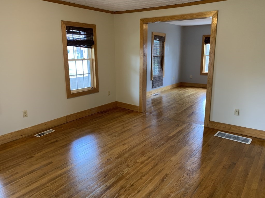 159 Chapman Street Greenfield, MA 01301 - Photo 10 of 36 a view of an empty room with wooden floor and a window