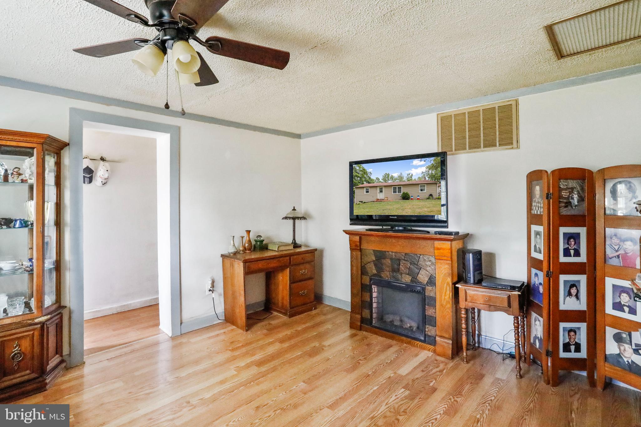 13618 Coppermine Road Union Bridge, MD 21791 - Photo 4 of 29 a living room with furniture and a flat screen tv