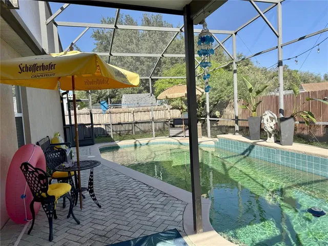 a front view of a house with a garden and trees