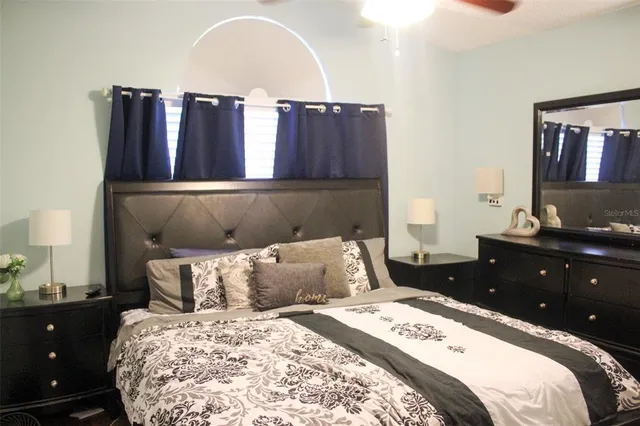 a bedroom with a bed and a desk