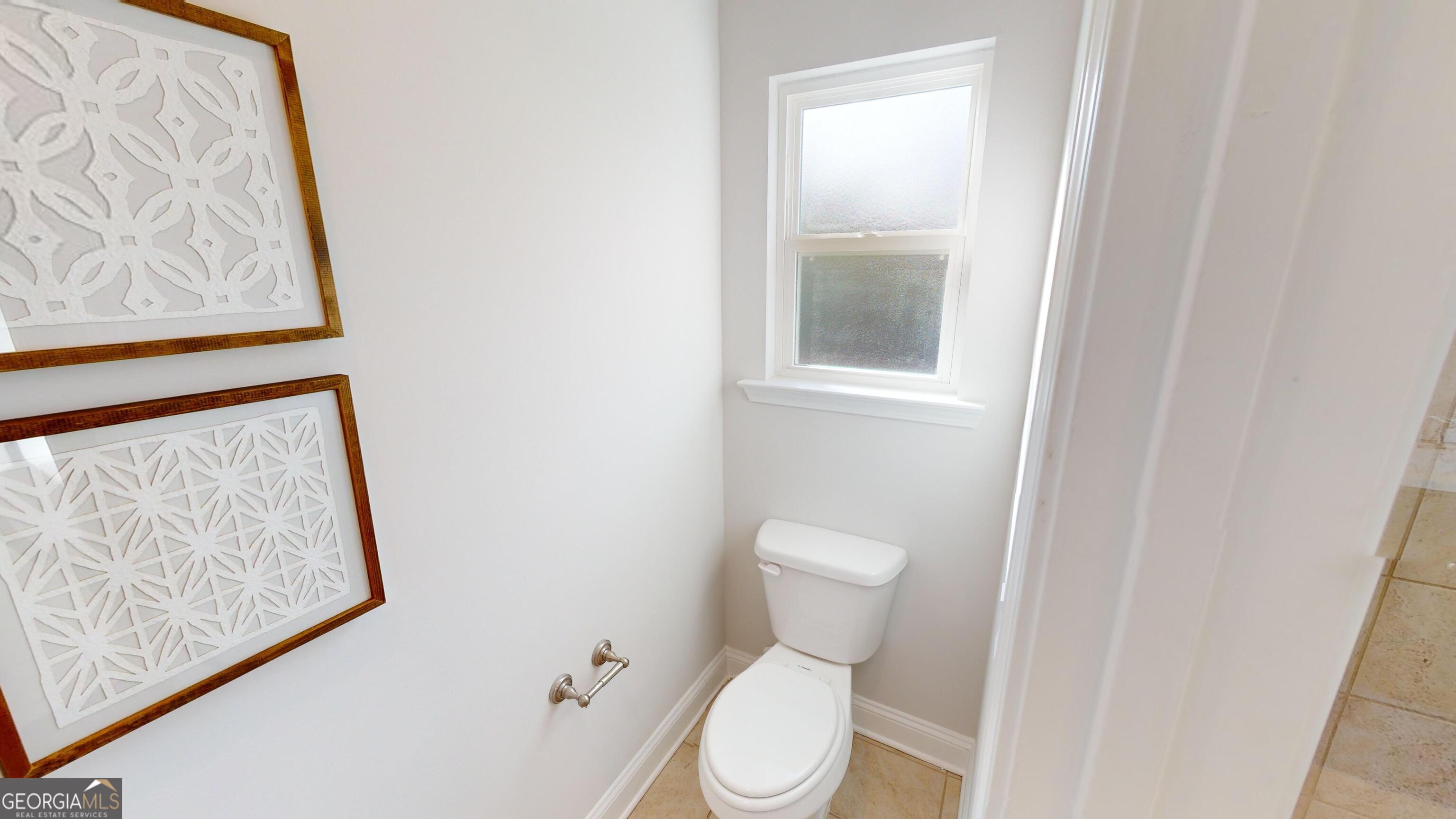 337 Stockton Circle Macon, GA 31216 - Photo 36 of 40 a white toilet sitting next to a small window