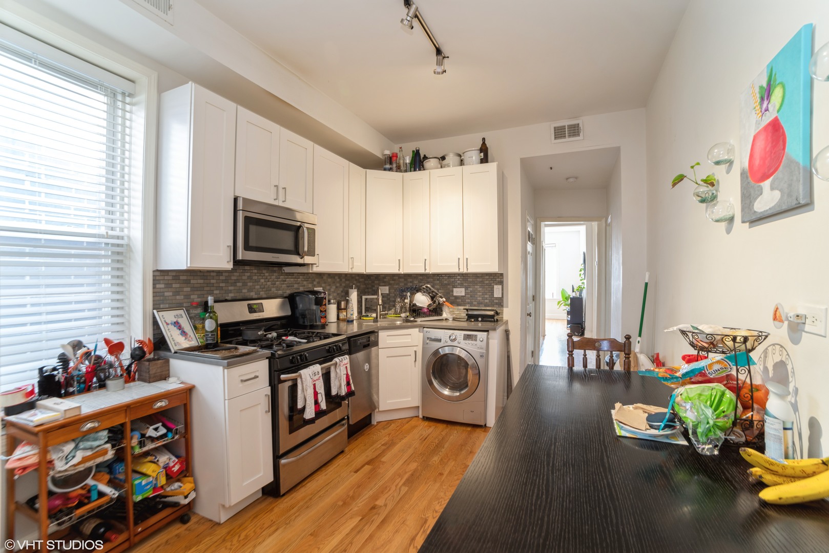 Undisclosed Address Chicago, IL 60647 - Photo 2 of 9 a kitchen with microwave a stove and wooden floor