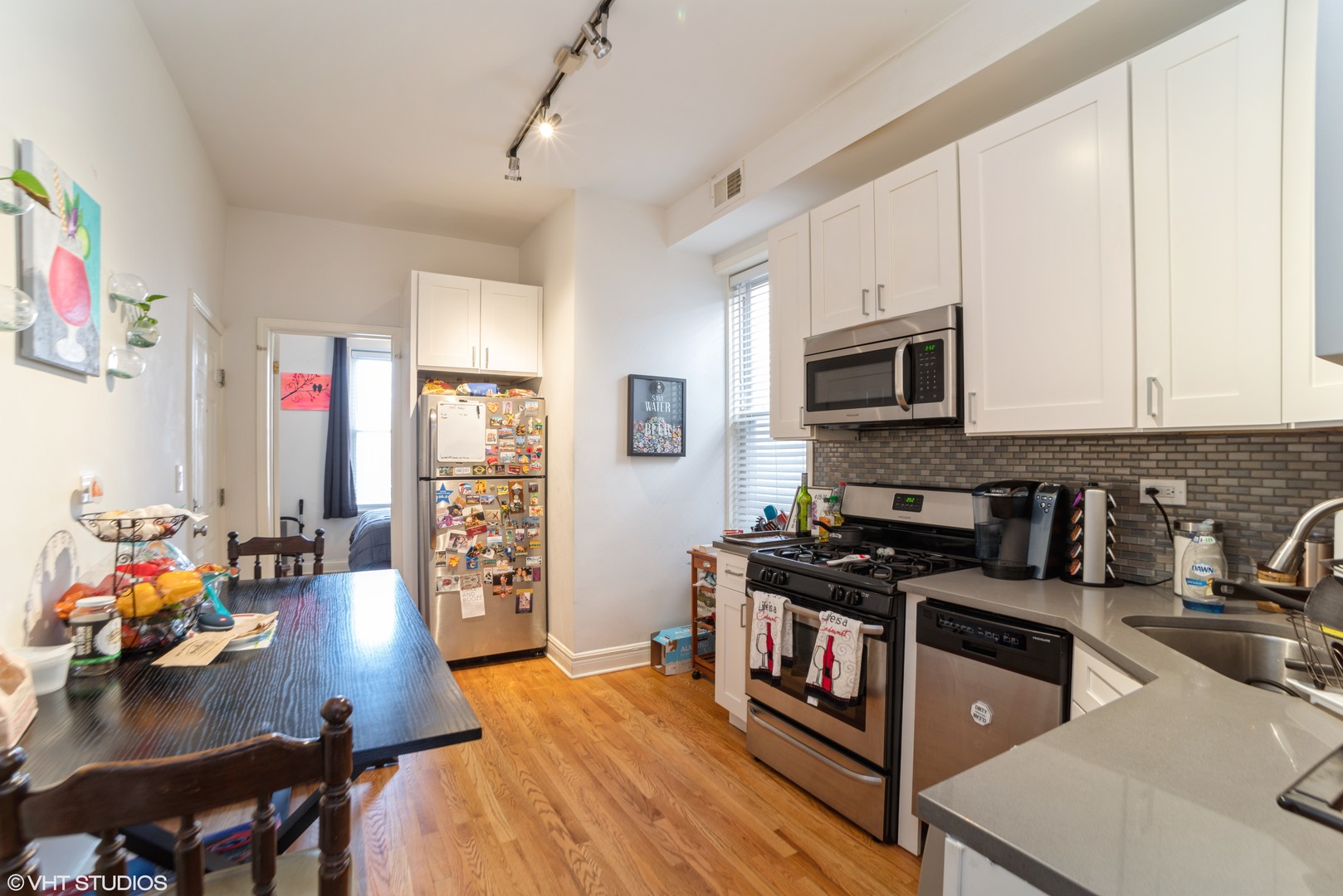 Undisclosed Address Chicago, IL 60647 - Photo 3 of 9 a kitchen that has a lot of cabinets a sink and appliances in it