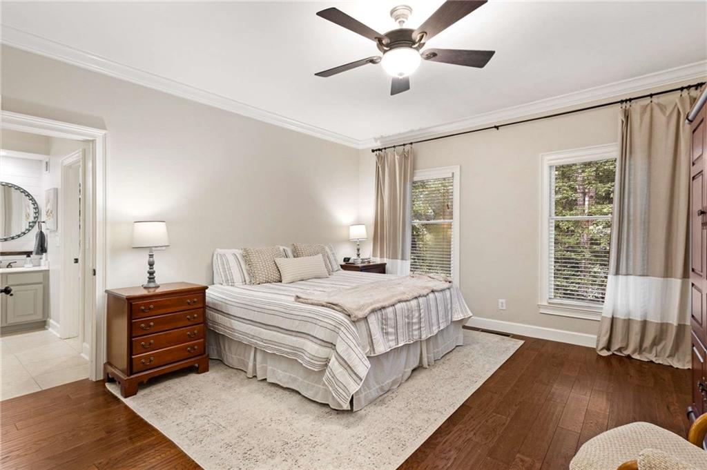 3728 Beaver Creek Road Gainesville, GA 30506 - Photo 7 of 28 a bedroom with a large bed chandelier and a window