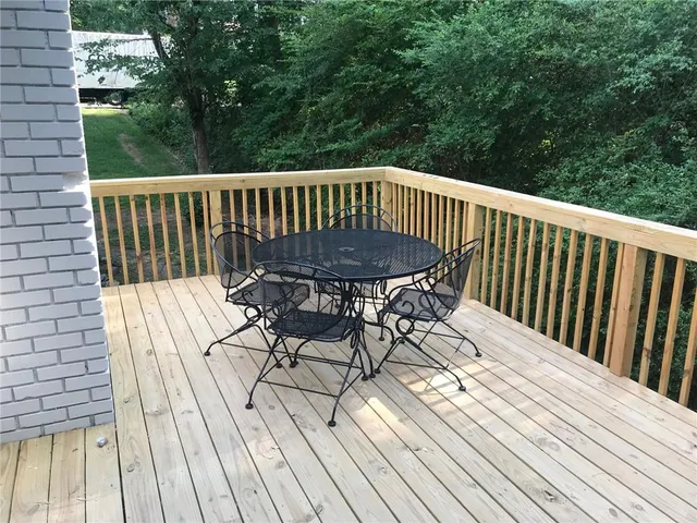 a view of balcony with wooden floor and outdoor seating