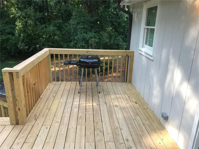 a view of balcony with wooden floor and outdoor seating