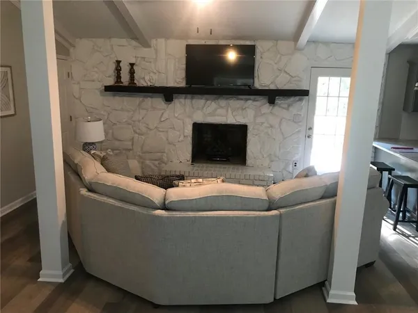 a living room with furniture and a flat screen tv