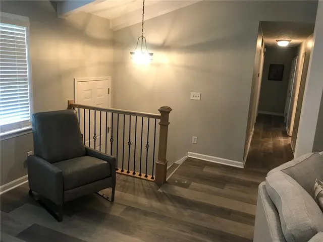 a view of a livingroom with furniture and staircase