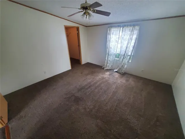 a bathroom with a granite countertop toilet and a sink