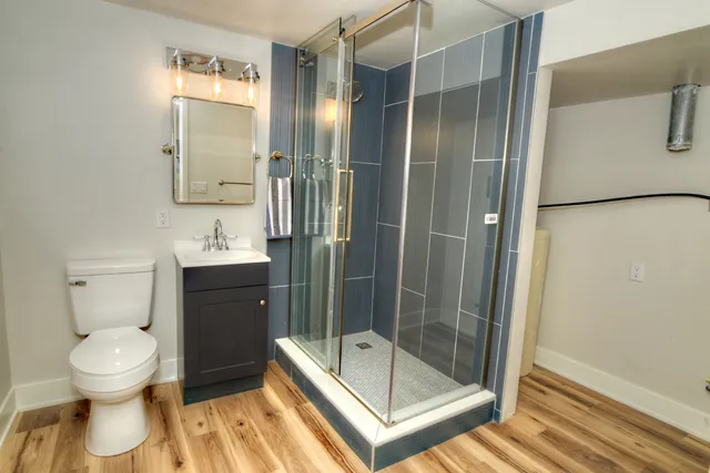 a bathroom with a toilet and a shower
