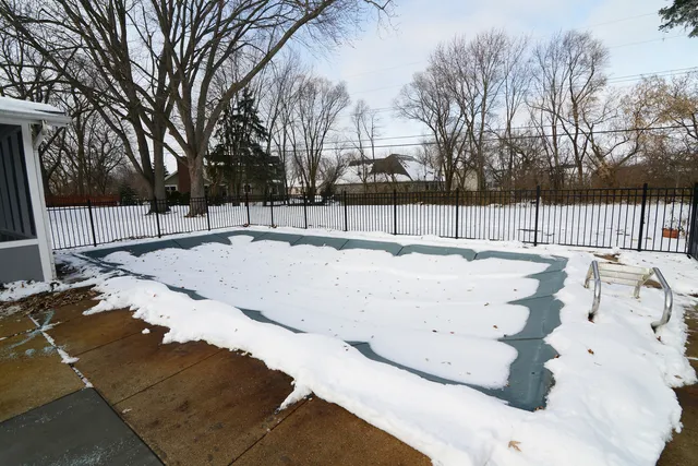 a swimming pool with trees in the background