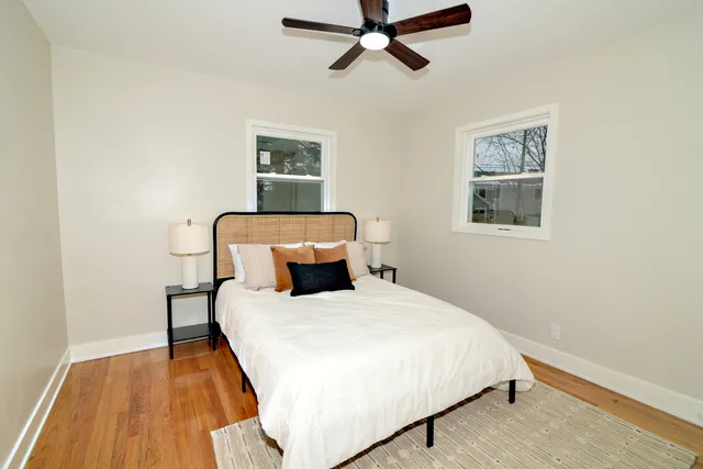 a bedroom with a bed and wooden floor