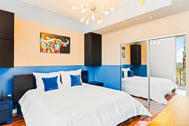 a bedroom with a bed and a chandelier