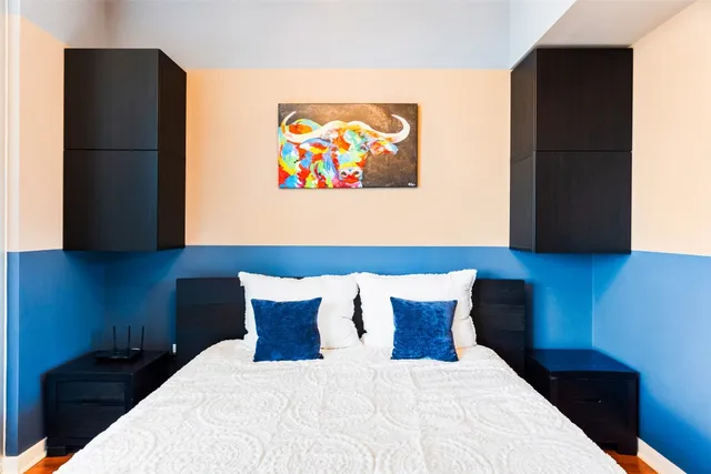 a bed room with a bed and a wall painting