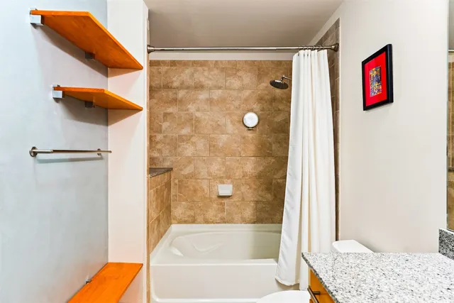 a bathroom with a shower and a bath tub