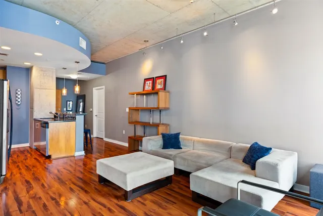 a living room with furniture and a wooden floor