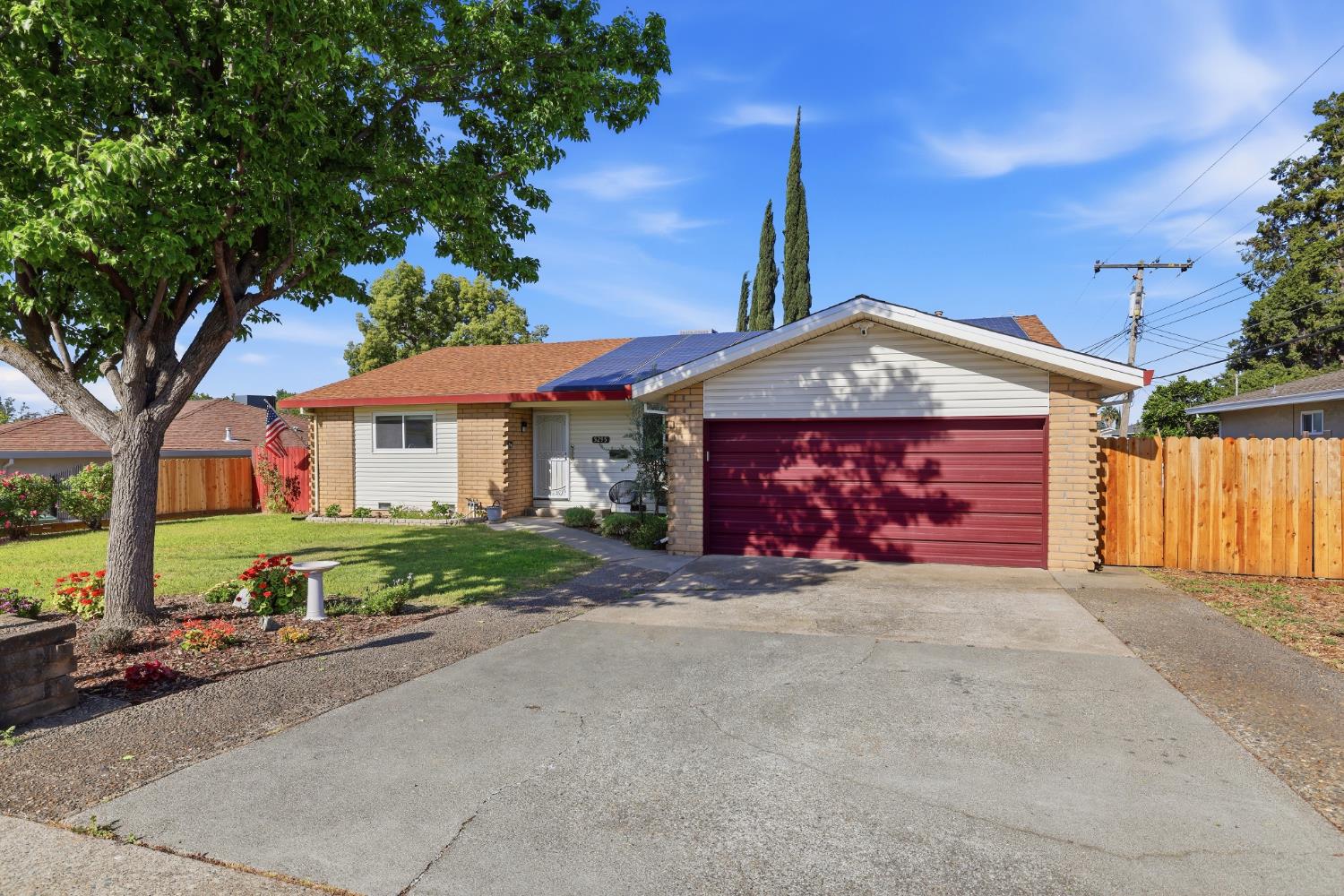 5295 Baumgart Way Carmichael, CA 95608 - Photo 1 of 46 a front view of a house with a garden and trees