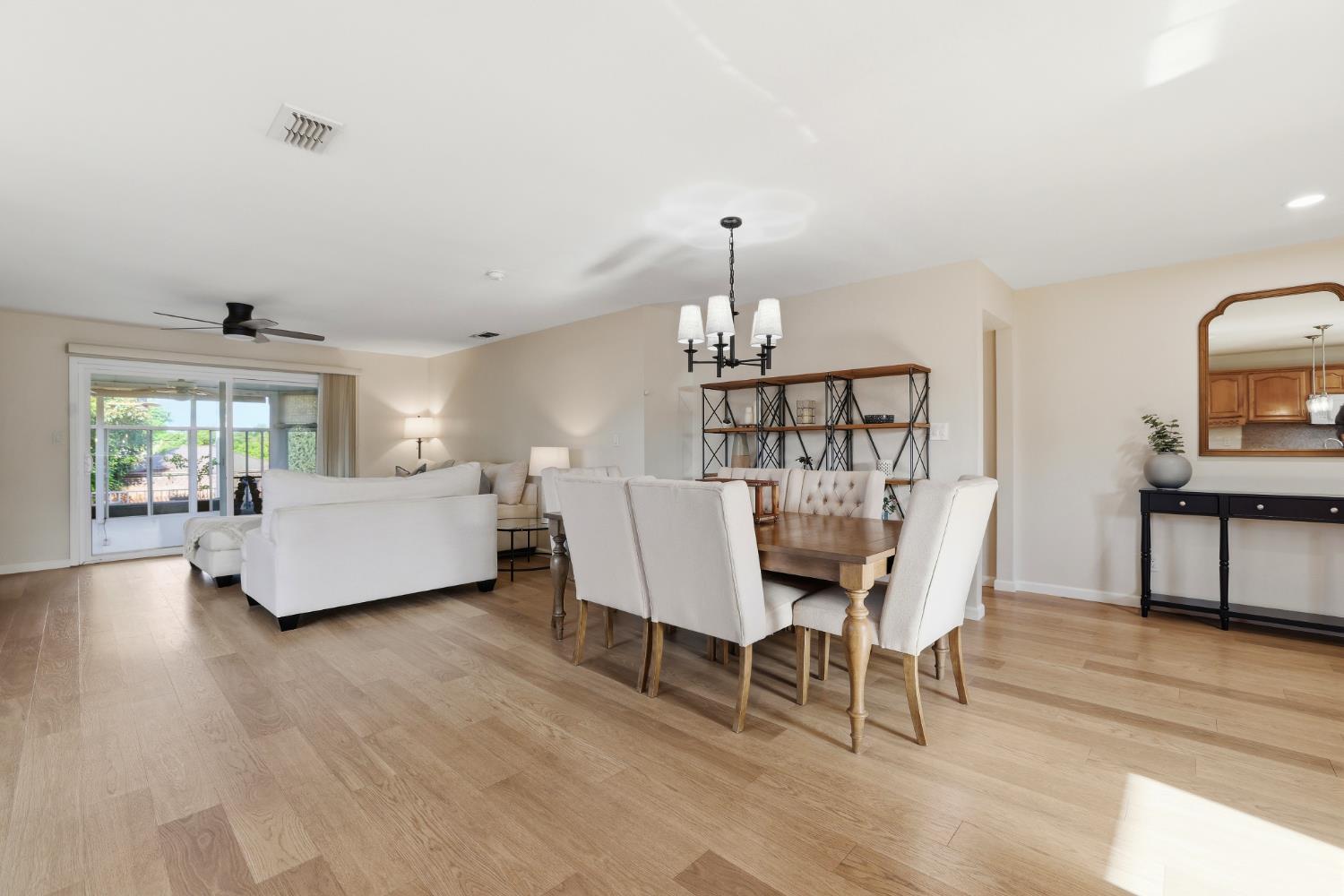 5295 Baumgart Way Carmichael, CA 95608 - Photo 12 of 46 a dining room with furniture a chandelier and wooden floor
