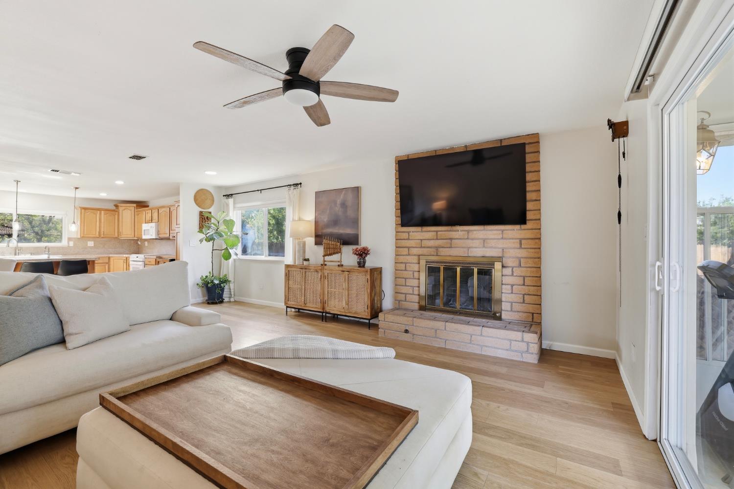 5295 Baumgart Way Carmichael, CA 95608 - Photo 15 of 46 a living room with furniture a fireplace and a flat screen tv