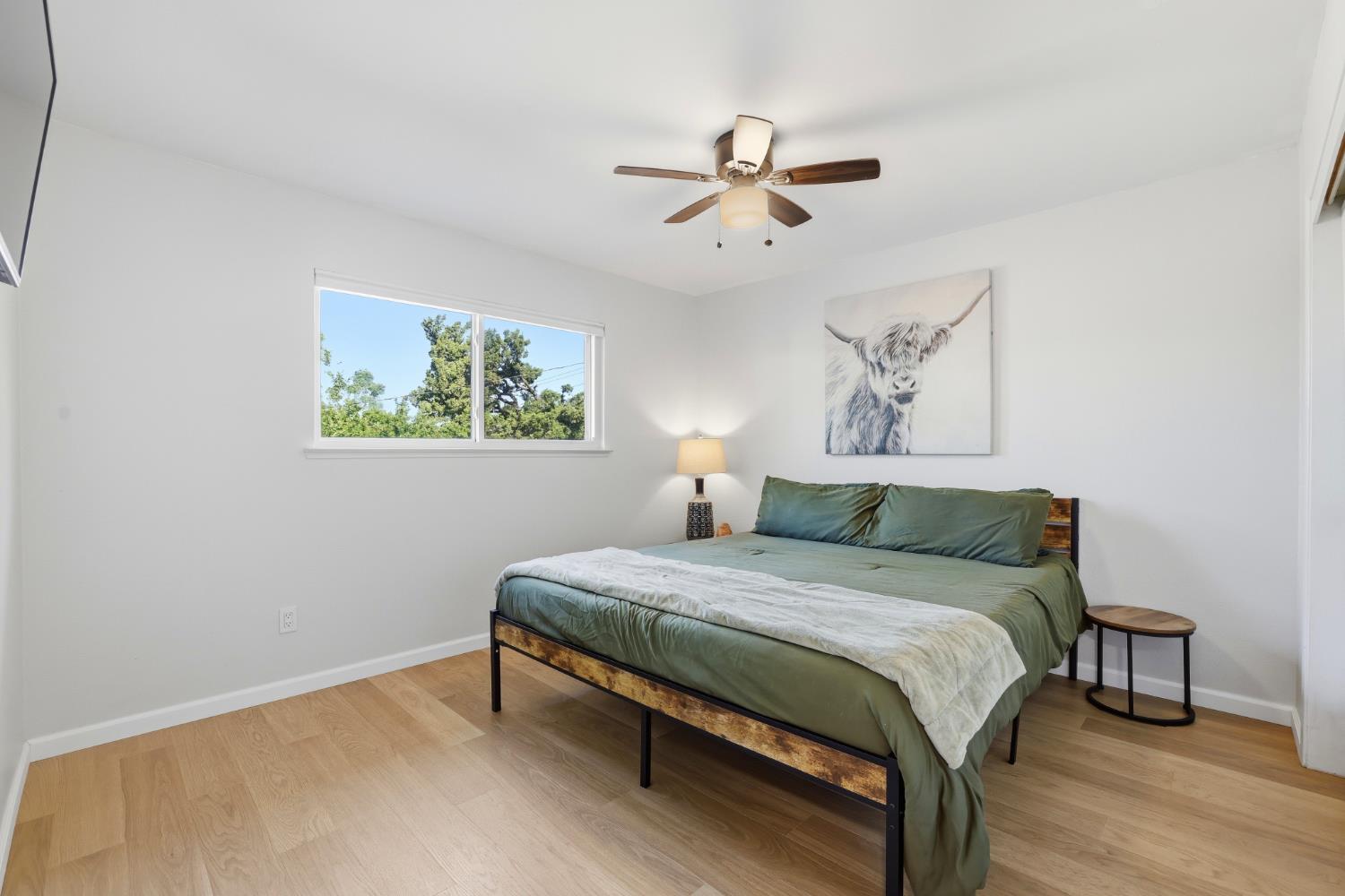 5295 Baumgart Way Carmichael, CA 95608 - Photo 16 of 46 a bedroom with a bed and a chandelier