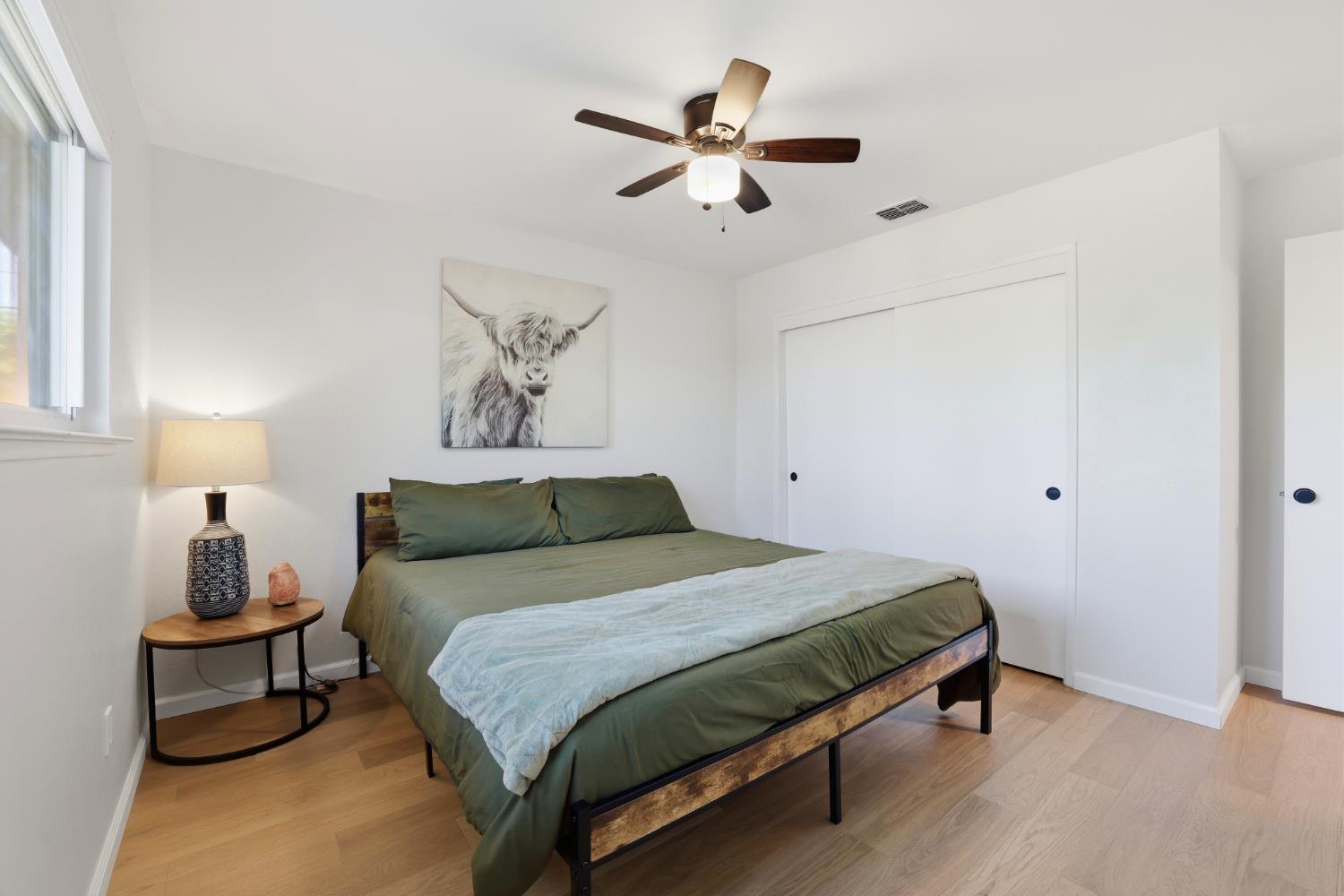 5295 Baumgart Way Carmichael, CA 95608 - Photo 17 of 46 a bedroom with a bed and a chandelier