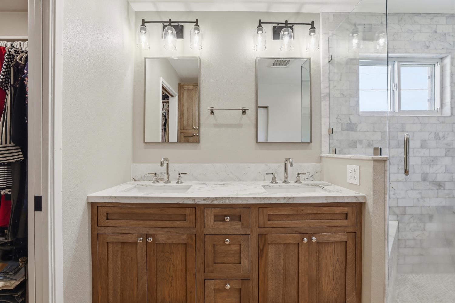 5295 Baumgart Way Carmichael, CA 95608 - Photo 24 of 46 a bathroom with a double vanity sink and mirror