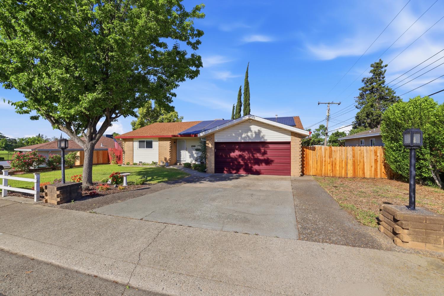 5295 Baumgart Way Carmichael, CA 95608 - Photo 3 of 46 a front view of a house with a yard and garage