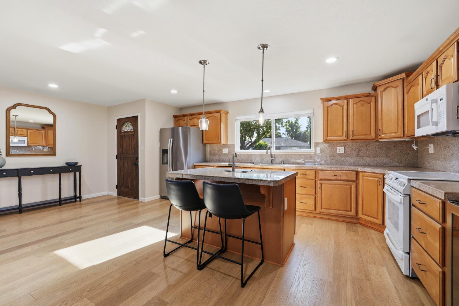5295 Baumgart Way Carmichael, CA 95608 - Photo 7 of 46 a kitchen with a table chairs sink and cabinets