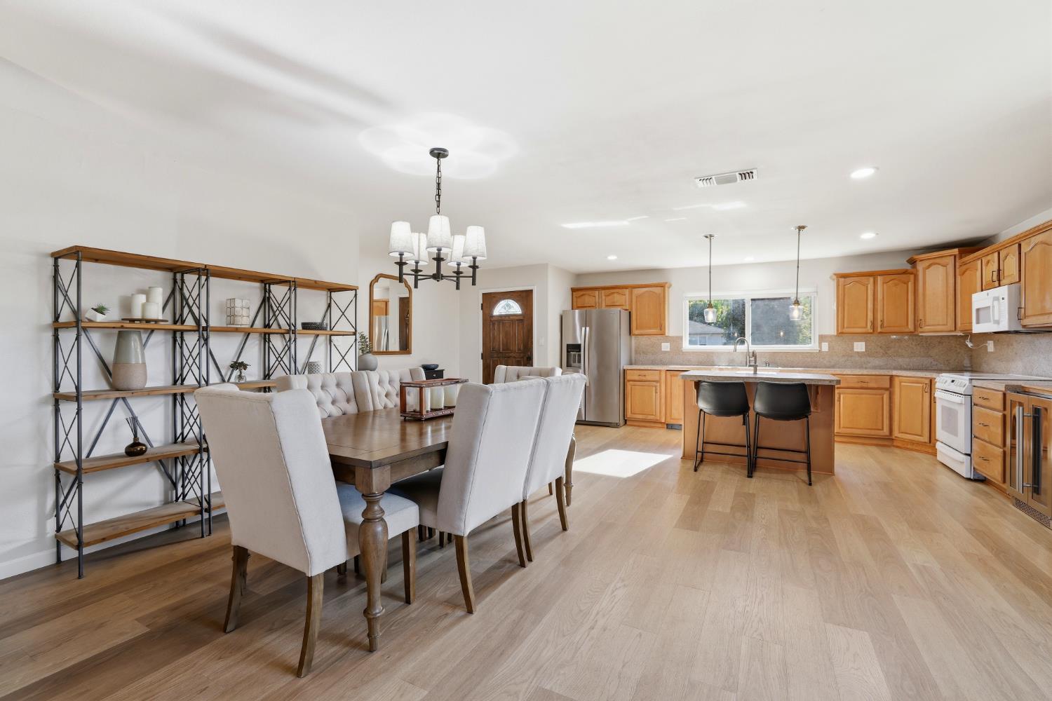 5295 Baumgart Way Carmichael, CA 95608 - Photo 10 of 46 a dining room with furniture a chandelier and wooden floor