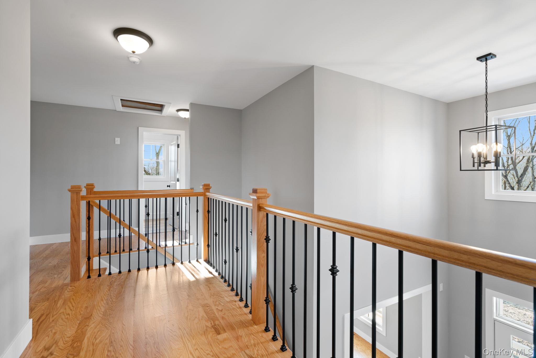 13 Harrier Ridge Drive Wallkill, NY 12589 - Photo 18 of 40 Corridor featuring an upstairs landing, light wood-style flooring, and attic access
