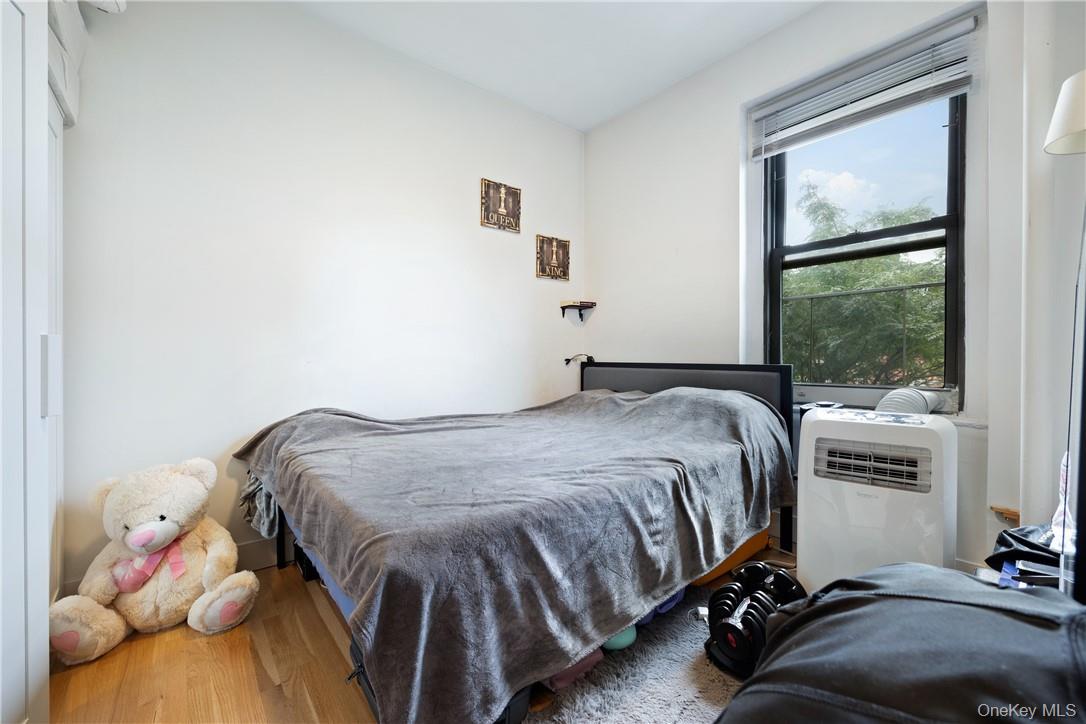 21-15 33rd Street, Unit 4E Queens, NY 11105 - Photo 8 of 13 a bedroom with a bed and window