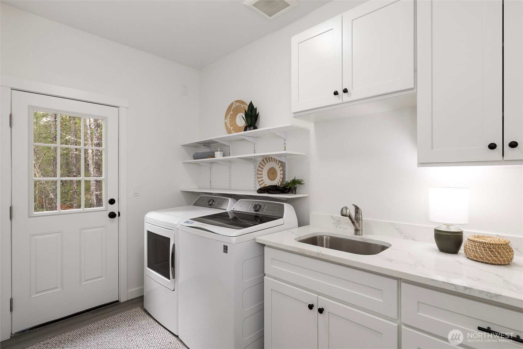 101 Northeast Anvil Lane Belfair, WA 98528 - Photo 25 of 40 a kitchen with white cabinets and white appliances