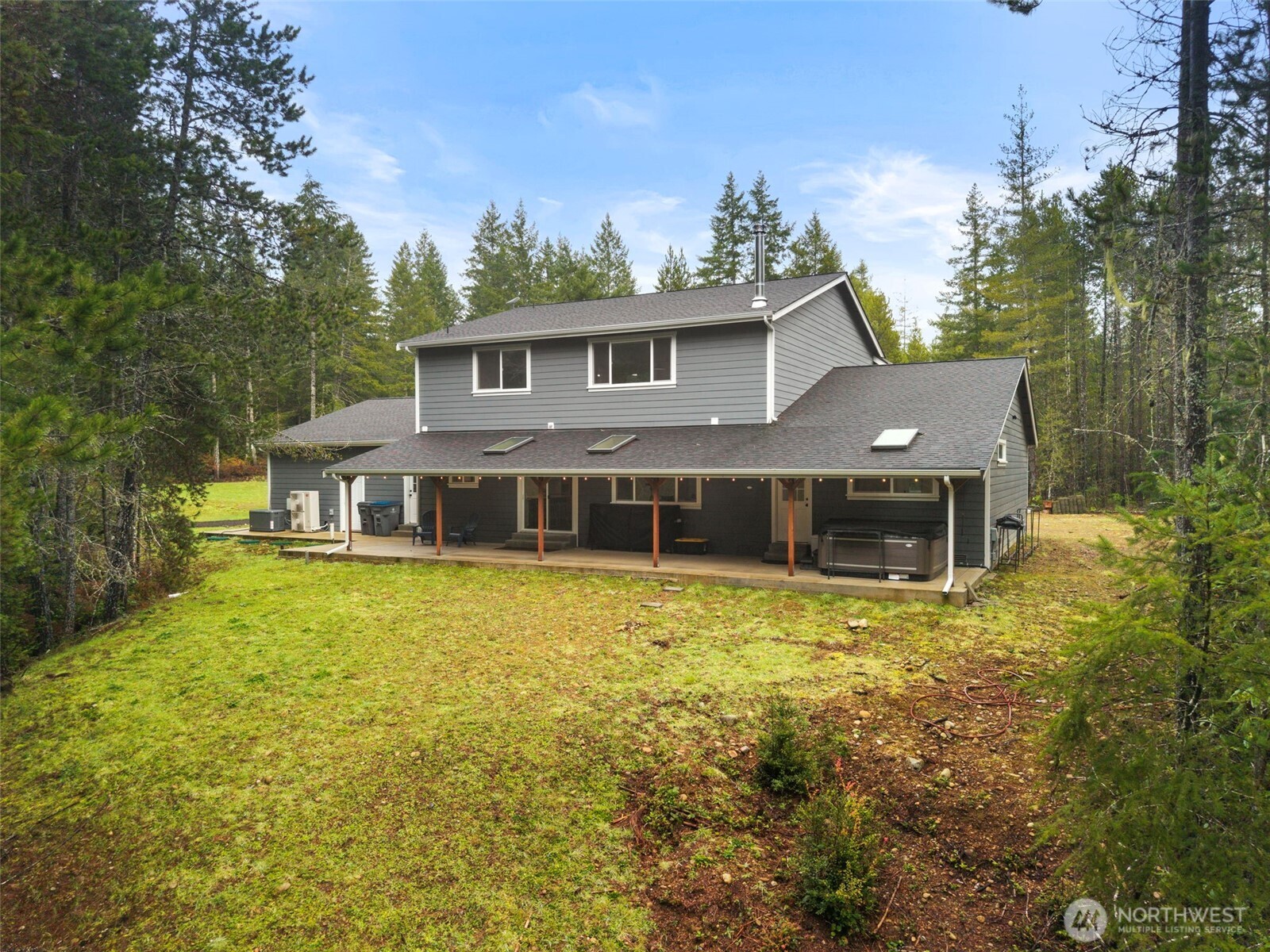 101 Northeast Anvil Lane Belfair, WA 98528 - Photo 37 of 40 a front view of a house with a garden