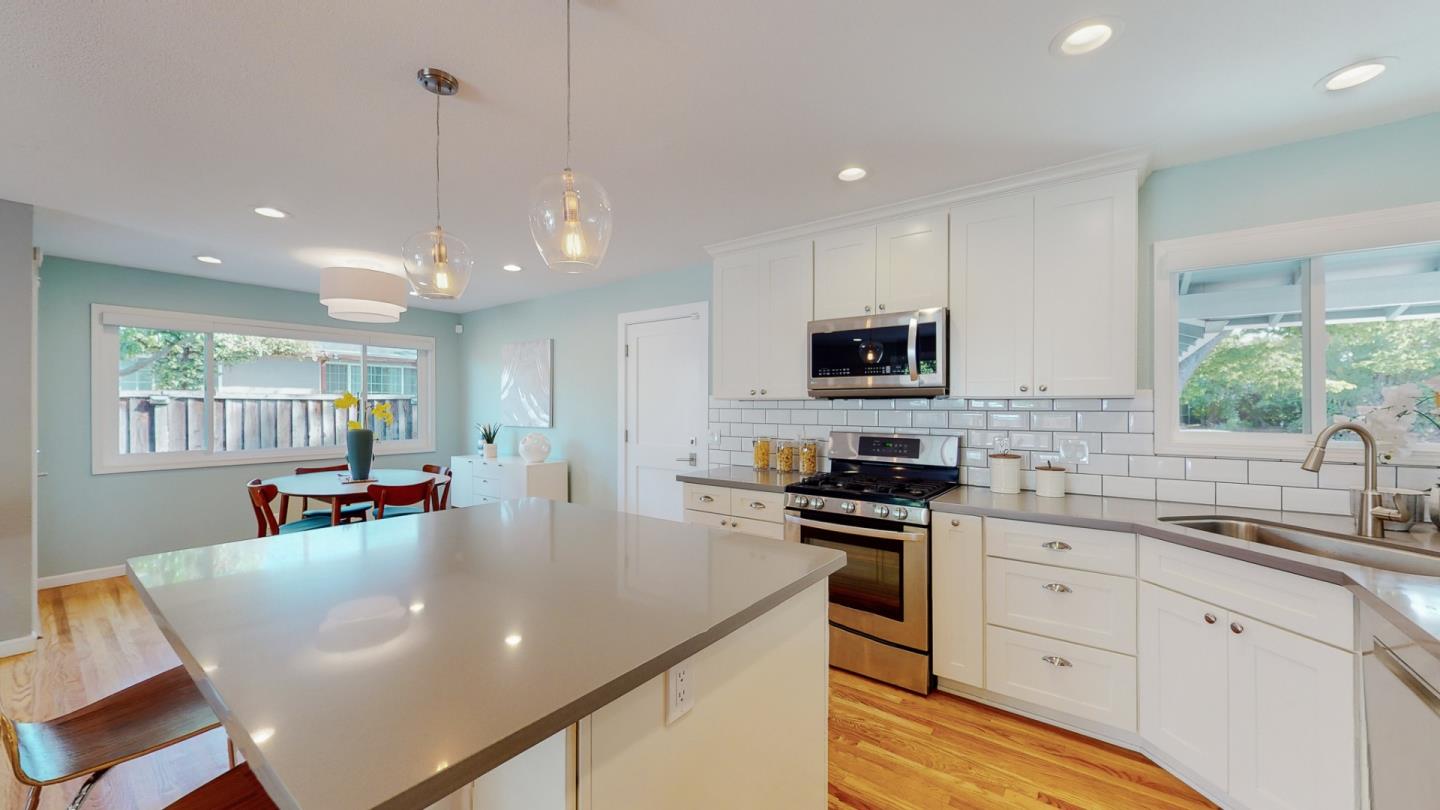 5378 Carter Avenue San Jose, CA 95118 - Photo 13 of 38 a kitchen with stainless steel appliances granite countertop a sink a stove a microwave a center island and furniture