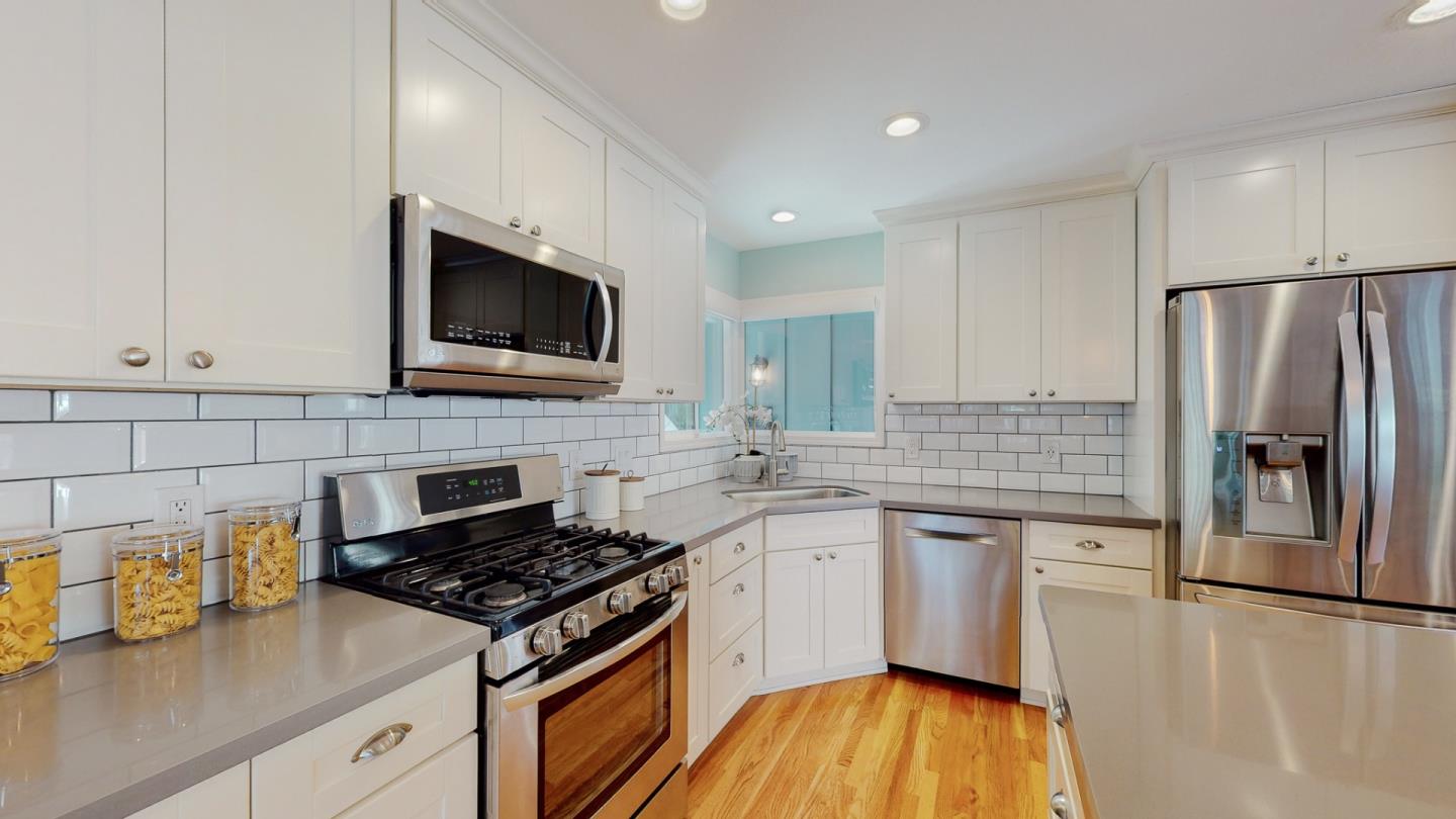 5378 Carter Avenue San Jose, CA 95118 - Photo 14 of 38 a kitchen with stainless steel appliances a stove microwave and sink